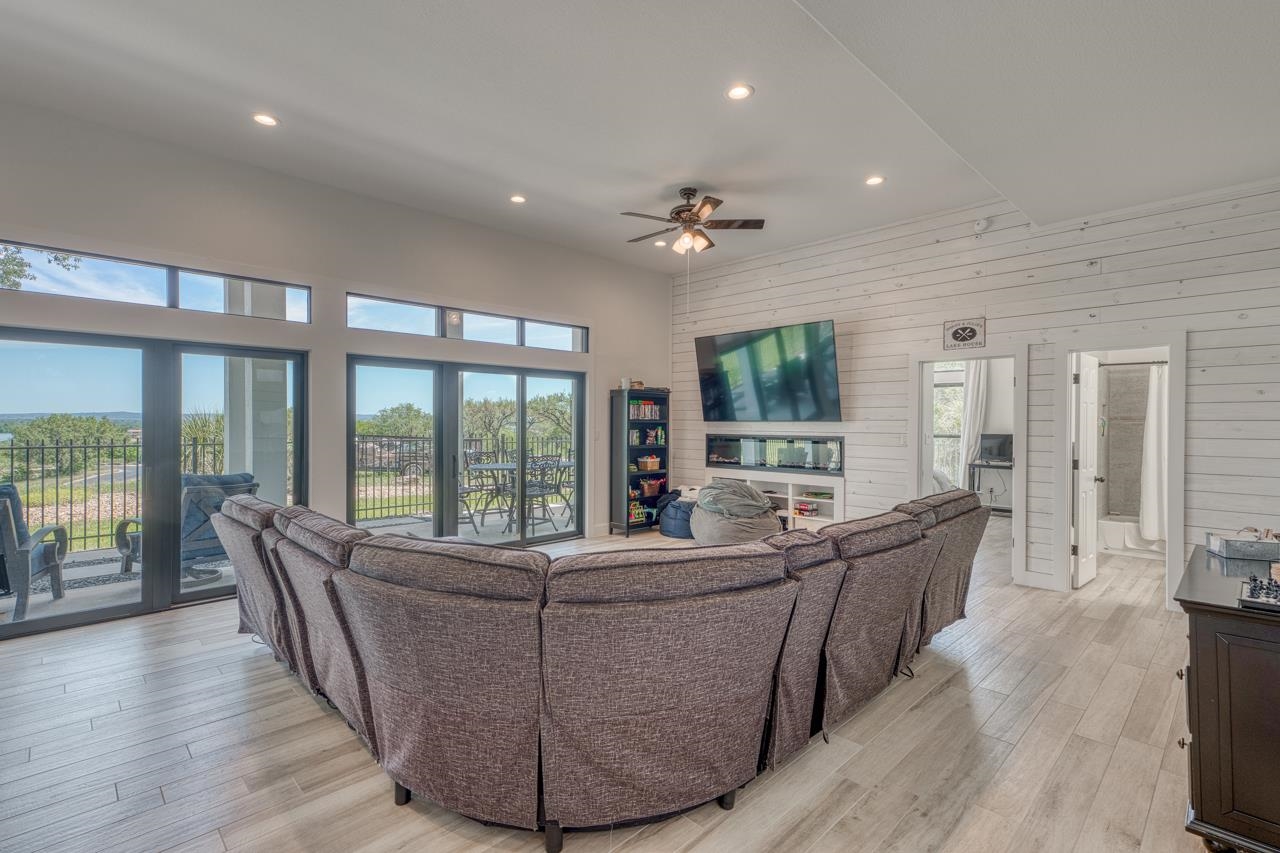 3305 Close Call Horseshoe Bay, TX 78657 - Photo 22 of 30 a living room with furniture large windows and wooden floor