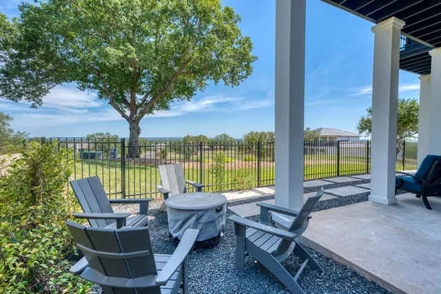 an aerial view of a house with a yard basket ball court and outdoor seating