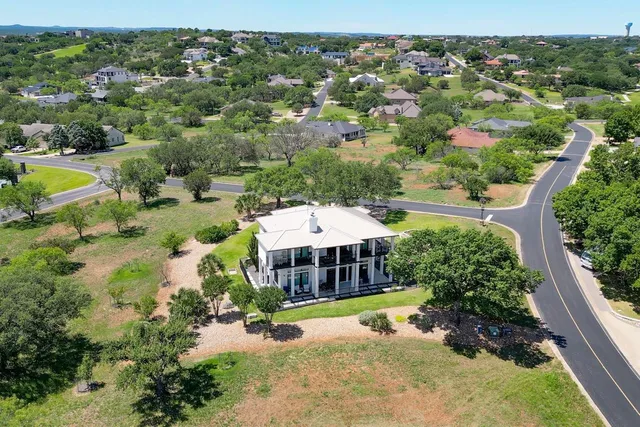 an aerial view of a houses with a yard