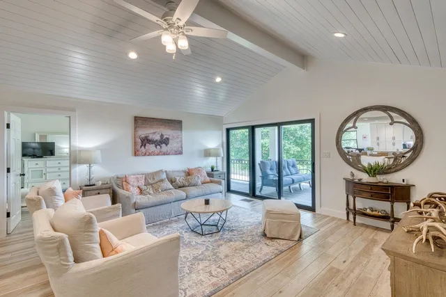 a living room with furniture and a chandelier