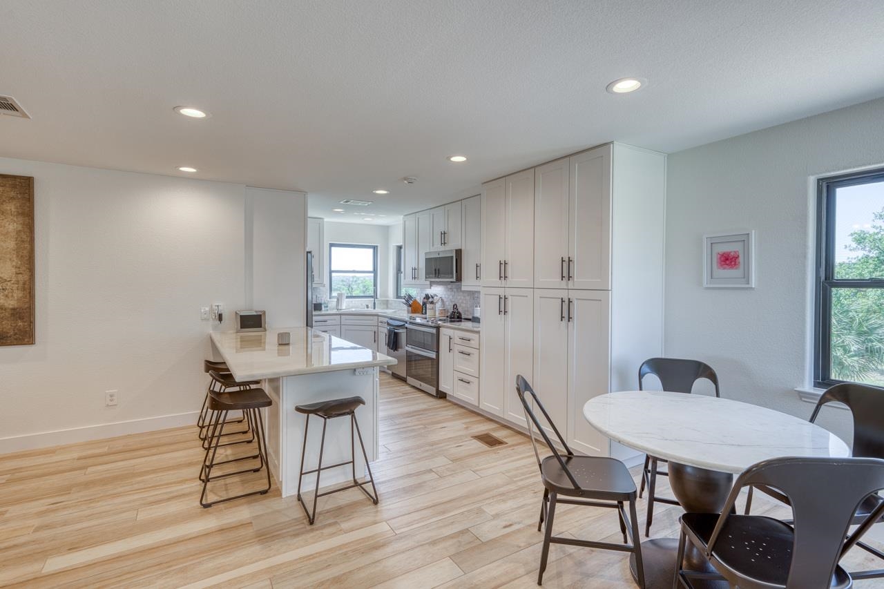 3305 Close Call Horseshoe Bay, TX 78657 - Photo 7 of 30 a view of a dining room with furniture and wooden floor