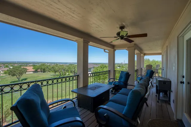 a view of a chair and table in the balcony