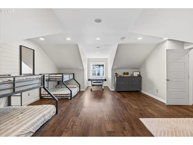 a bedroom with a large bed and a large window