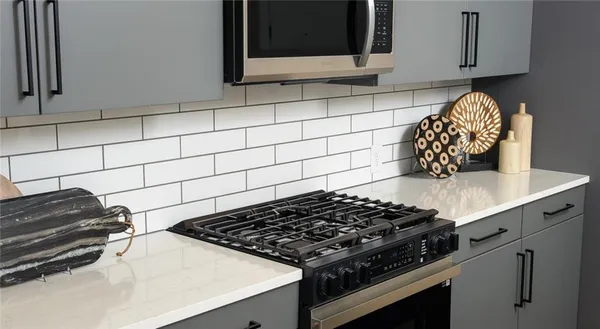 a stove top oven sitting inside of a kitchen