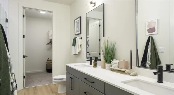 a bathroom with a sink a toilet and a mirror