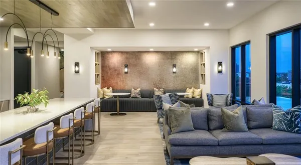 a living room with furniture and a chandelier