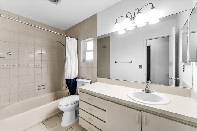 a bathroom with a sink a toilet and a large mirror