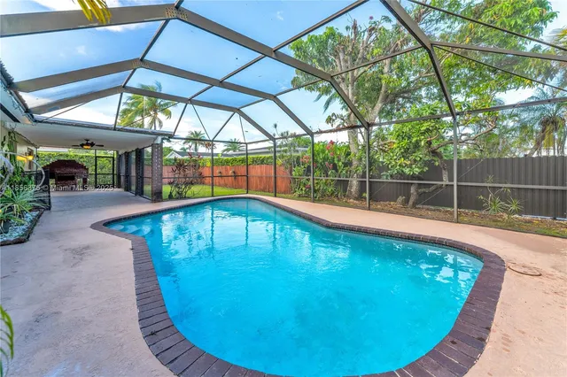 a view of a swimming pools under an umbrella