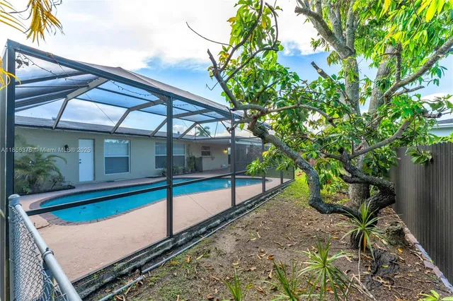 a view of a backyard with a small deck and a garden
