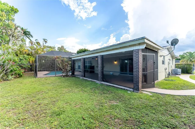 a view of a house with backyard and porch