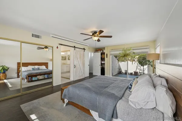 a spacious bedroom with a bed and a chandelier