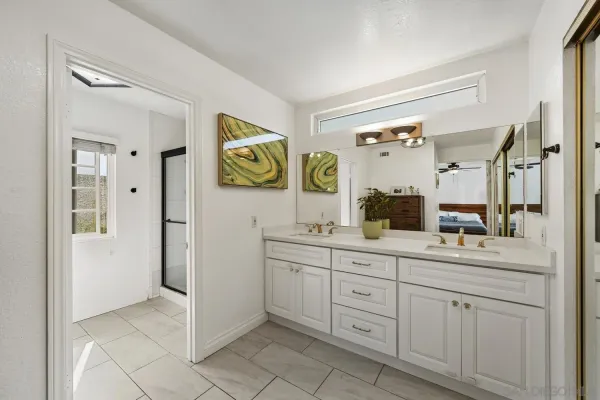 a spacious bathroom with a sink mirror and a shower