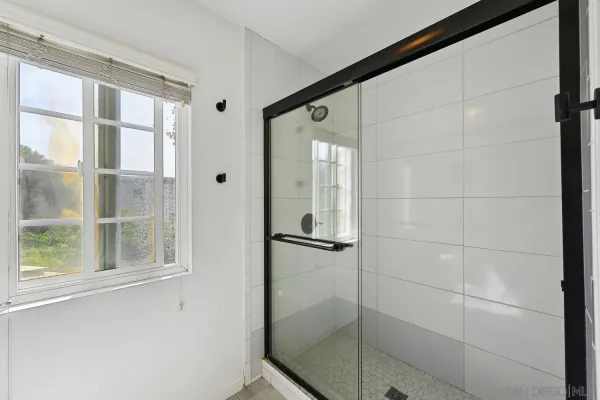 a bathroom with a glass shower door