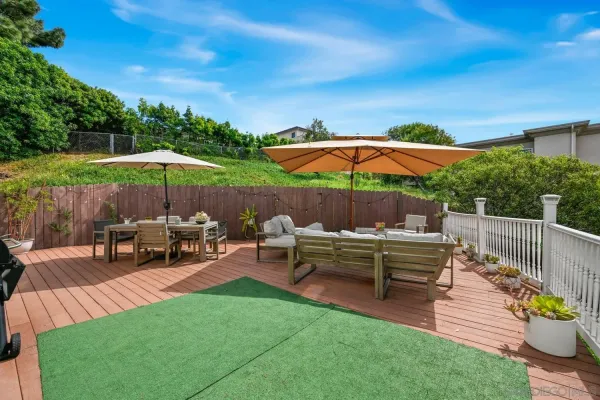 a view of backyard with seating space and trees