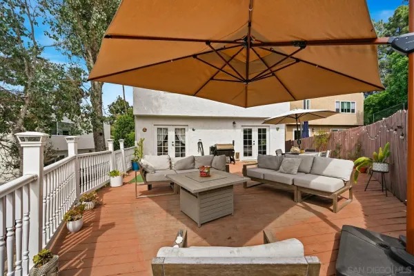 a outdoor space with patio the couches and pool with an umbrella