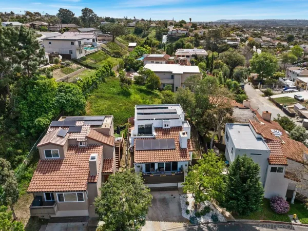 an aerial view of residential houses with city view