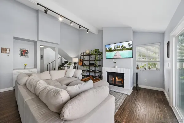 a living room with furniture fireplace and wooden floor