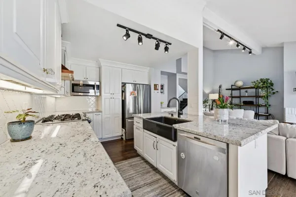 a kitchen with sink stove and refrigerator