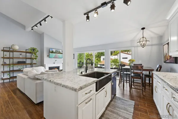 a kitchen with stainless steel appliances granite countertop sink stove and wooden cabinets