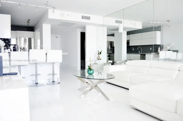 a living room with furniture a fireplace and kitchen view