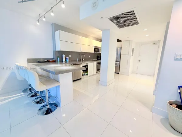 a kitchen with a sink cabinets and window