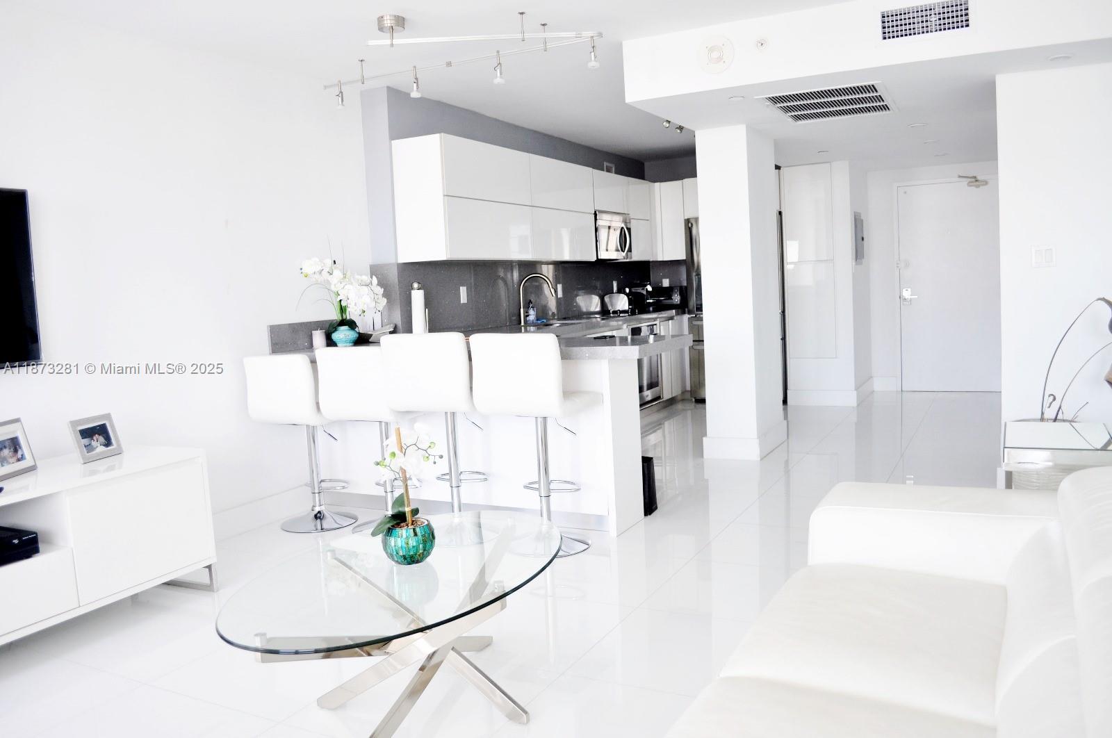 100 Lincoln Road, Unit 1504 Miami Beach, FL 33139 - Photo 3 of 12 a view of kitchen and living room