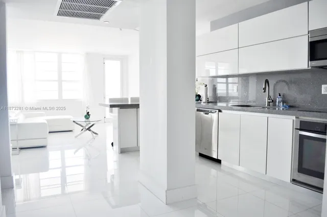 a kitchen with stainless steel appliances granite countertop a stove microwave and sink