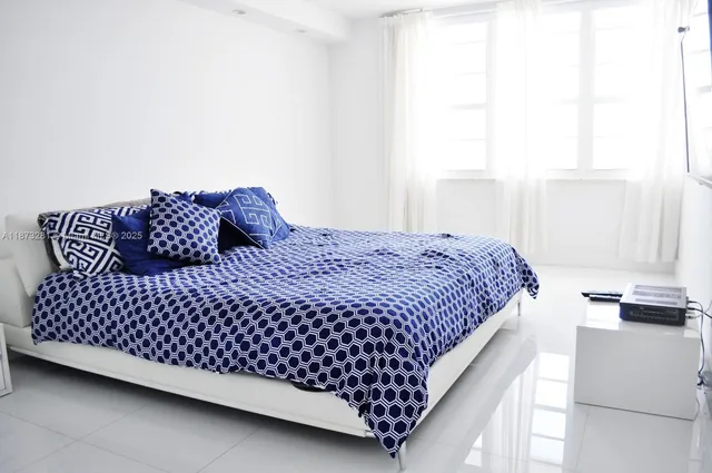 a bedroom with a bed and window