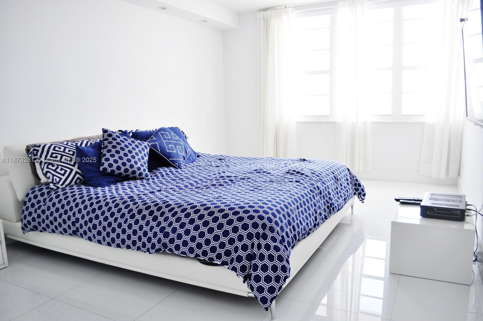 100 Lincoln Road, Unit 1504 Miami Beach, FL 33139 - Photo 6 of 12 a bedroom with a bed and window