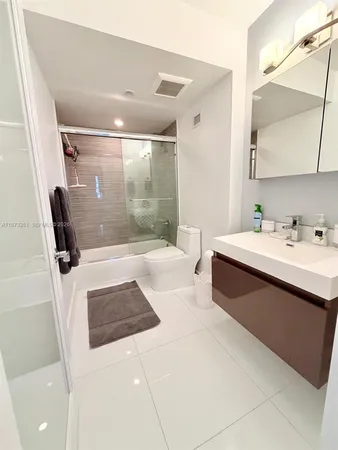 a bathroom with a sink a mirror and a shower