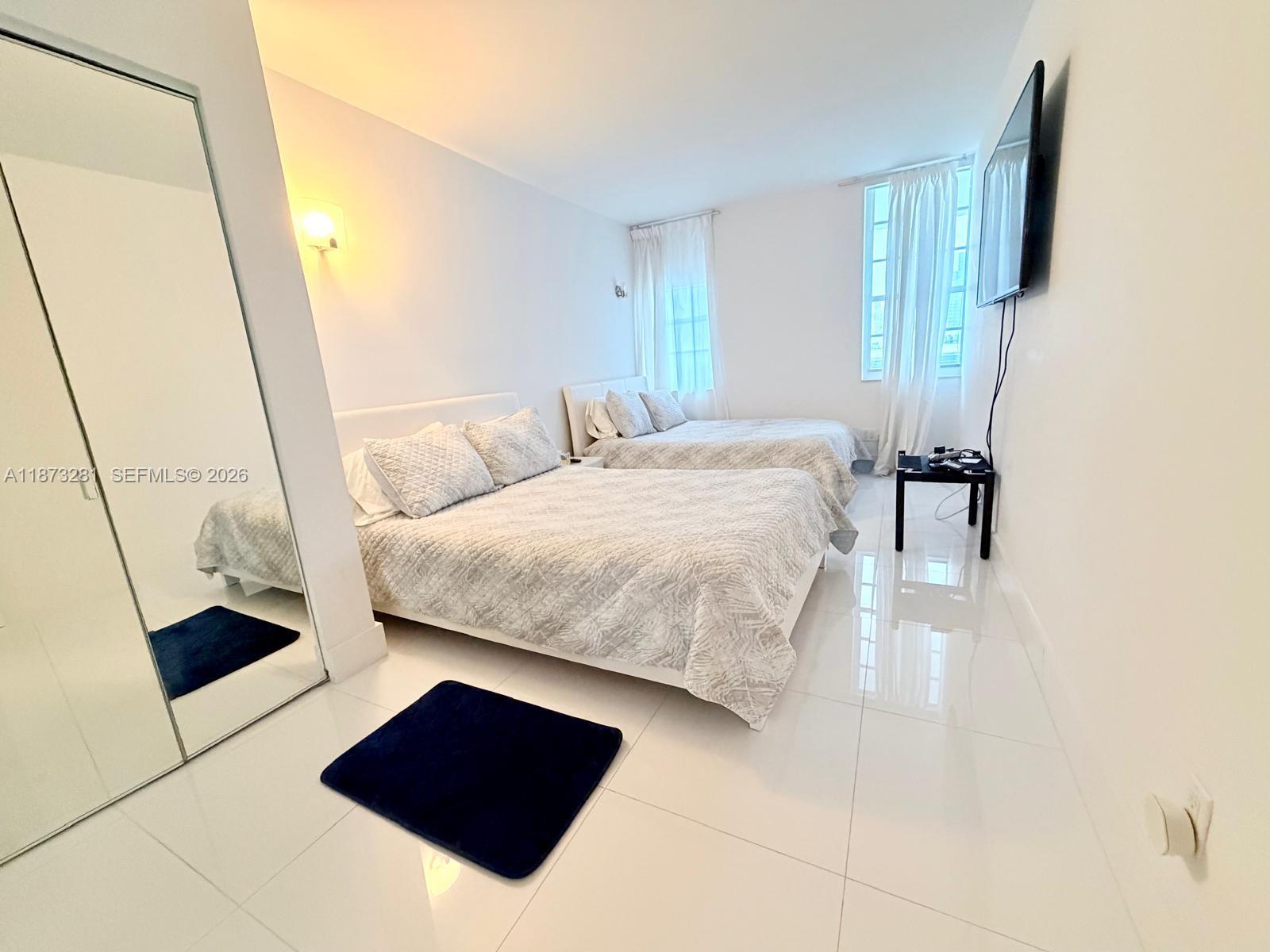 100 Lincoln Road, Unit 1504 Miami Beach, FL 33139 - Photo 7 of 15 a bedroom with a bed and a rug