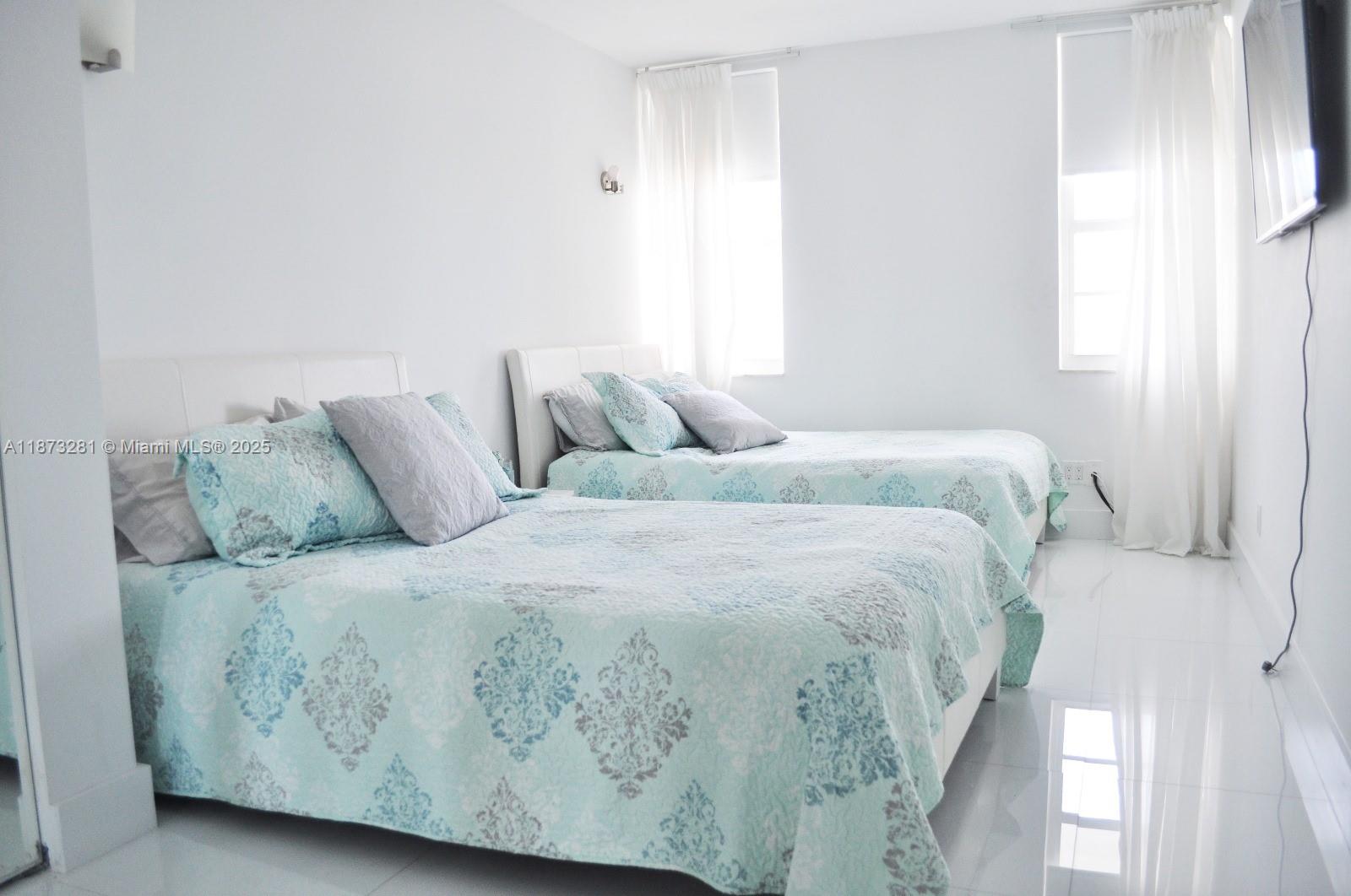 100 Lincoln Road, Unit 1504 Miami Beach, FL 33139 - Photo 9 of 12 a bedroom with a bed and a window