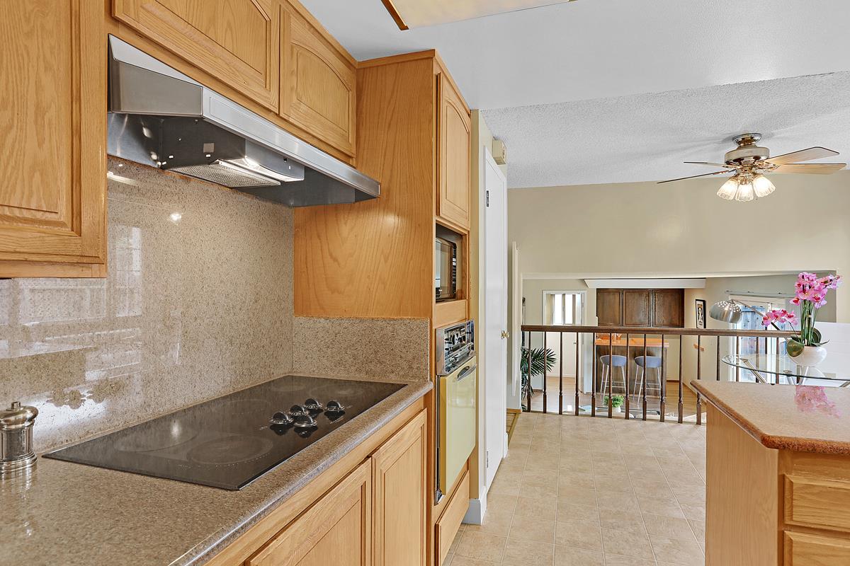 773 Crestview Drive Millbrae, CA 94030 - Photo 11 of 40 a kitchen with stainless steel appliances granite countertop a stove a sink and a refrigerator