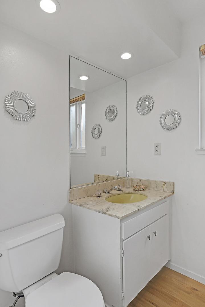 773 Crestview Drive Millbrae, CA 94030 - Photo 19 of 40 a spacious bathroom with a granite countertop toilet sink and mirror