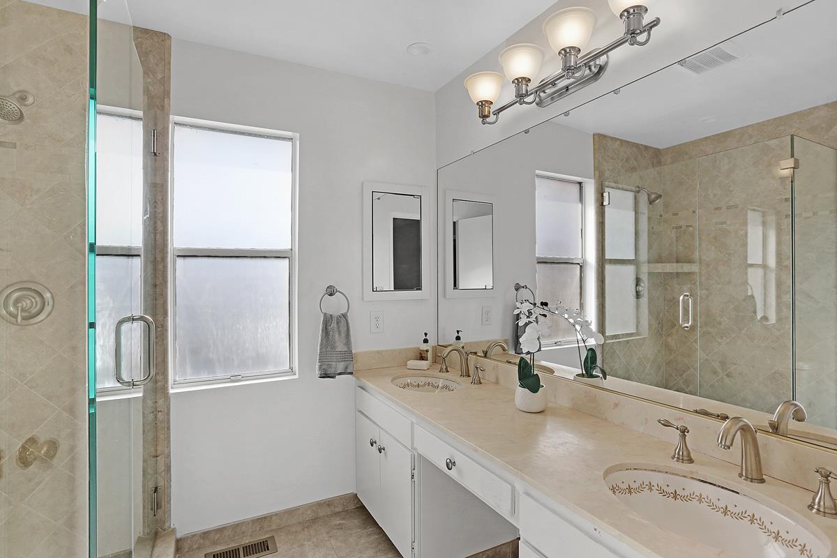 773 Crestview Drive Millbrae, CA 94030 - Photo 22 of 40 a bathroom with a double vanity sink a mirror and a shower