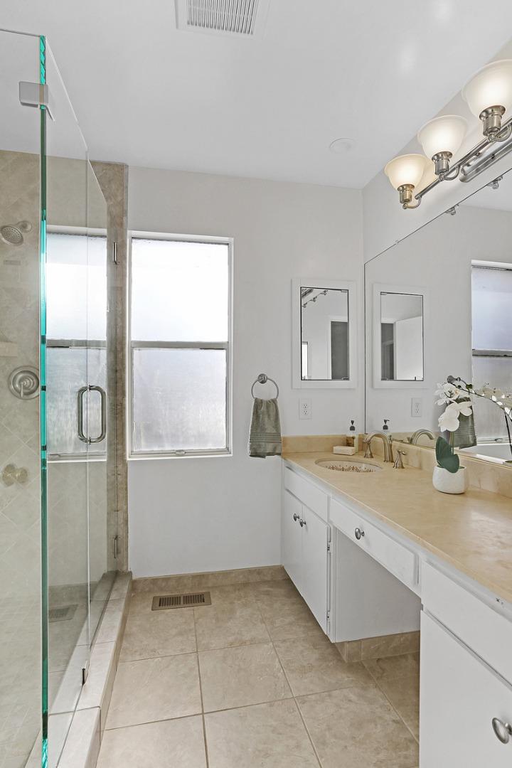 773 Crestview Drive Millbrae, CA 94030 - Photo 23 of 40 a spacious bathroom with a granite countertop sink a mirror and a shower