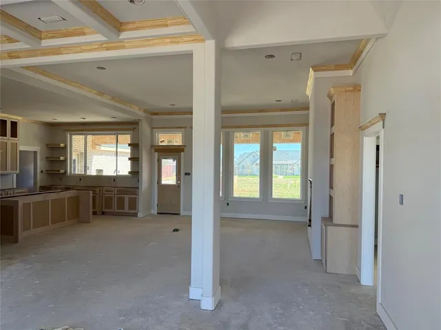 a view of a hallway with kitchen and entryway