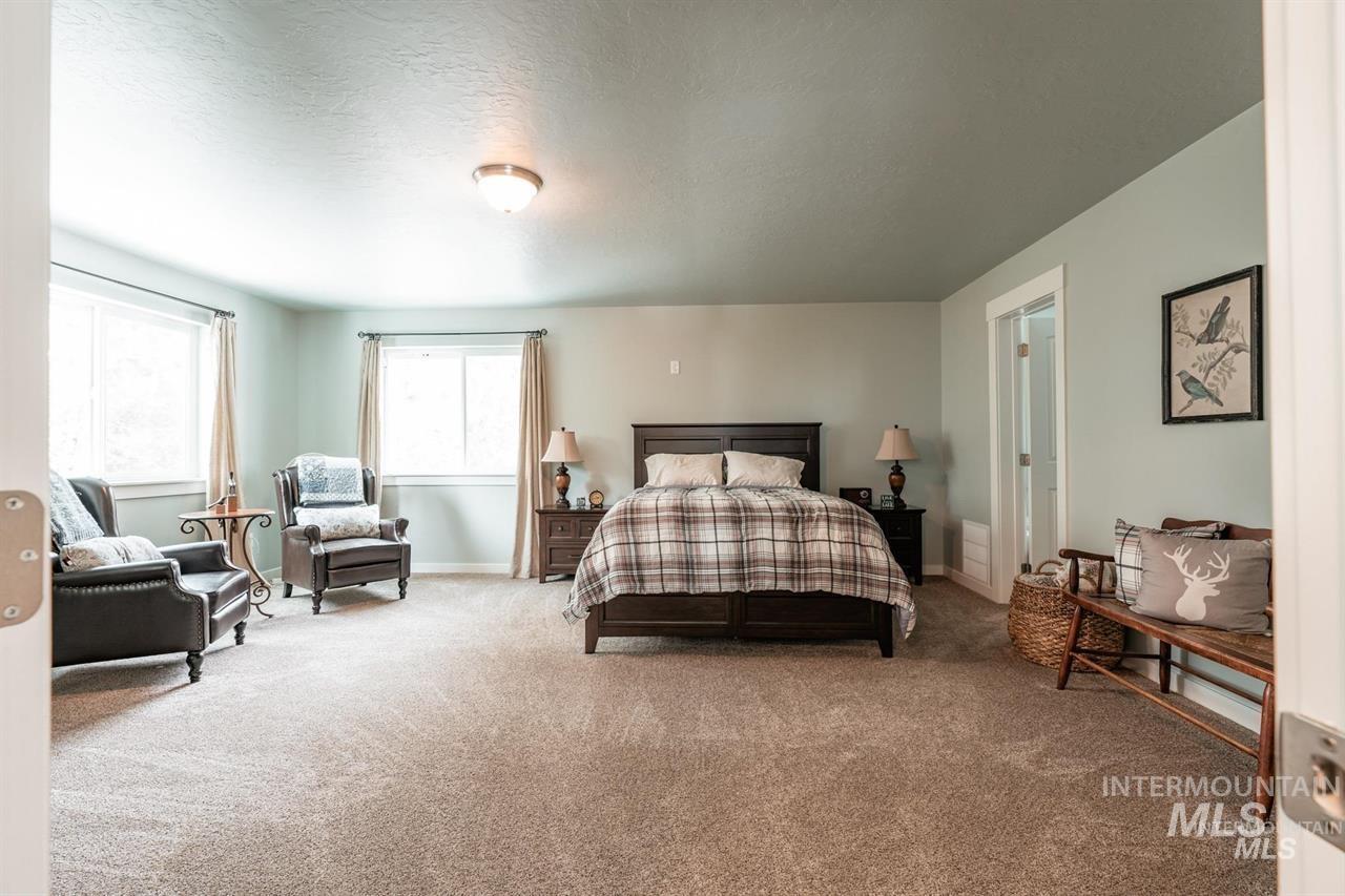 21 Melonie Loop Cascade, ID 83611 - Photo 15 of 27 Spacious bedroom featuring light-colored walls, recessed lighting, and soft carpet flooring