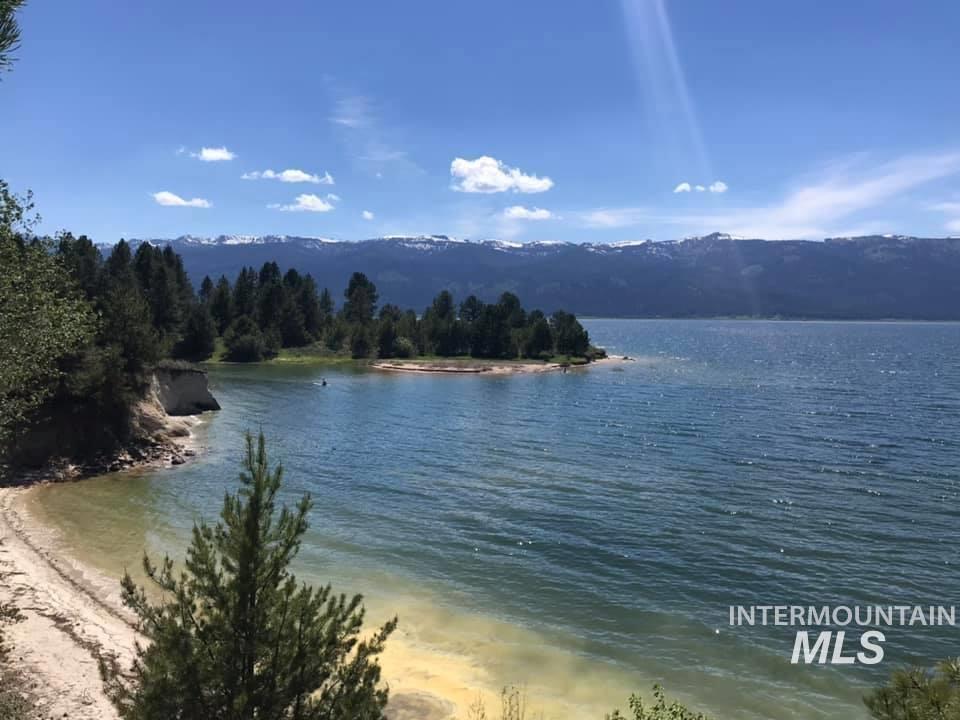 21 Melonie Loop Cascade, ID 83611 - Photo 25 of 27 Expansive waterfront property featuring a sandy shoreline, mature evergreen trees, and distant snow-capped mountains