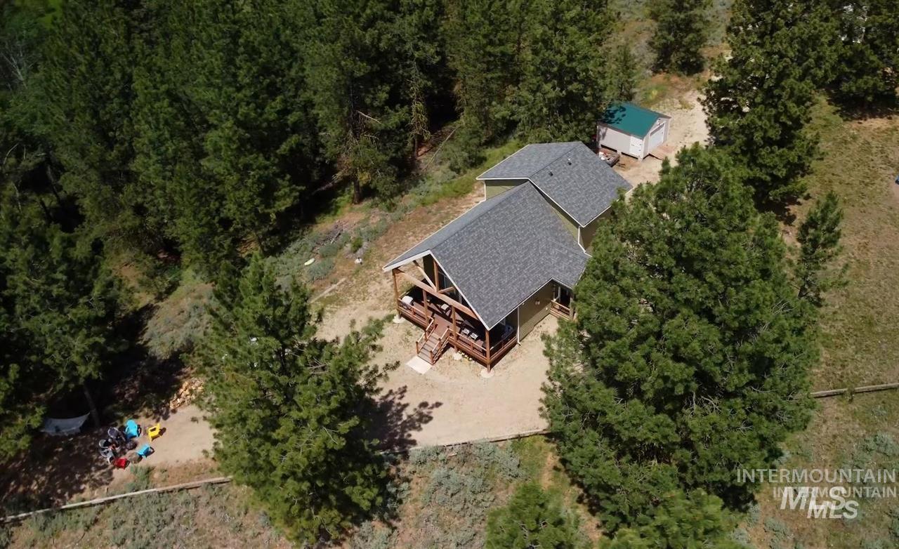 21 Melonie Loop Cascade, ID 83611 - Photo 3 of 27 Wooded property featuring a multi-level home with a gabled roof