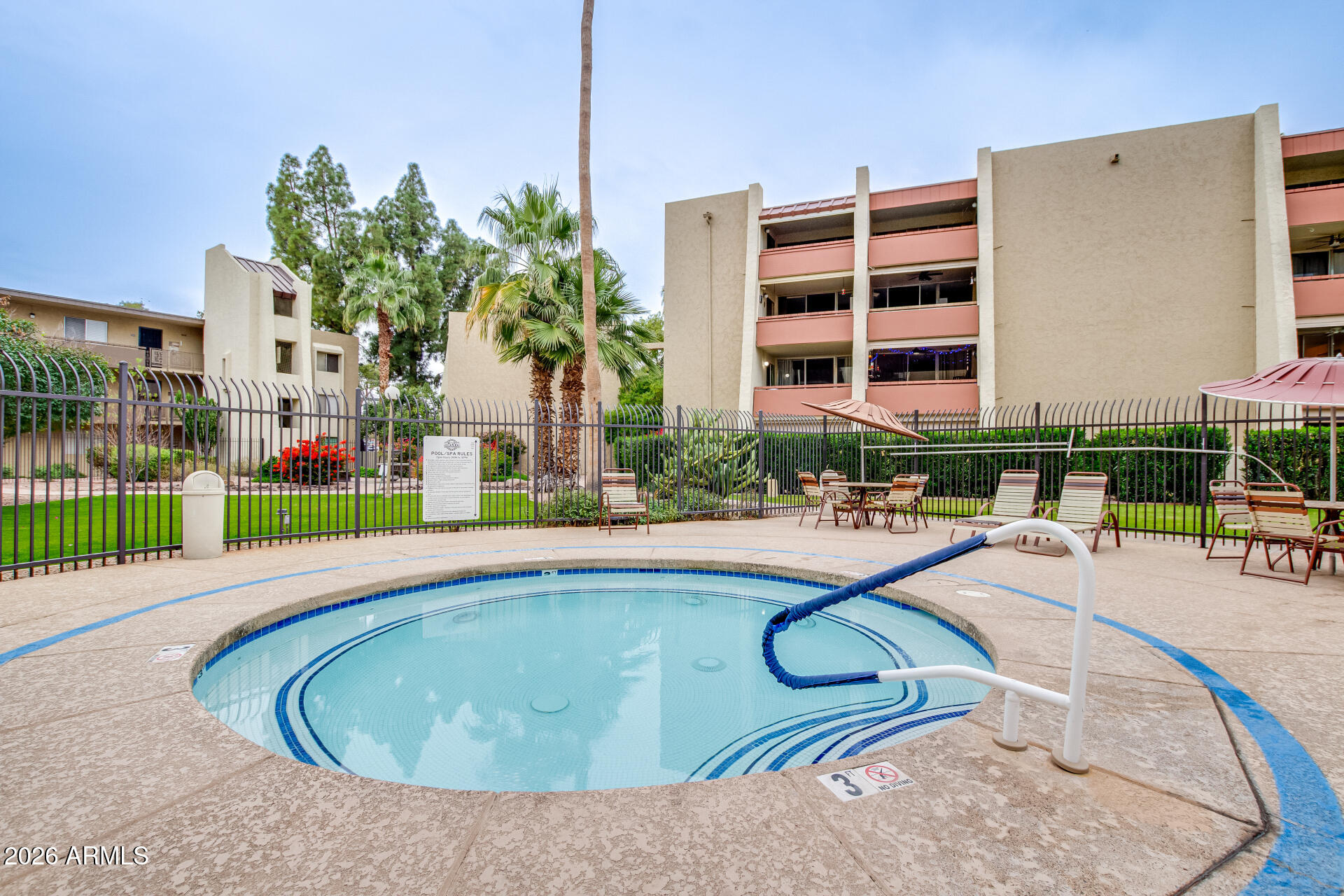 7625 East Camelback Road, Unit A220 Scottsdale, AZ 85251 - Photo 12 of 37 a swimming pool with outdoor seating and yard