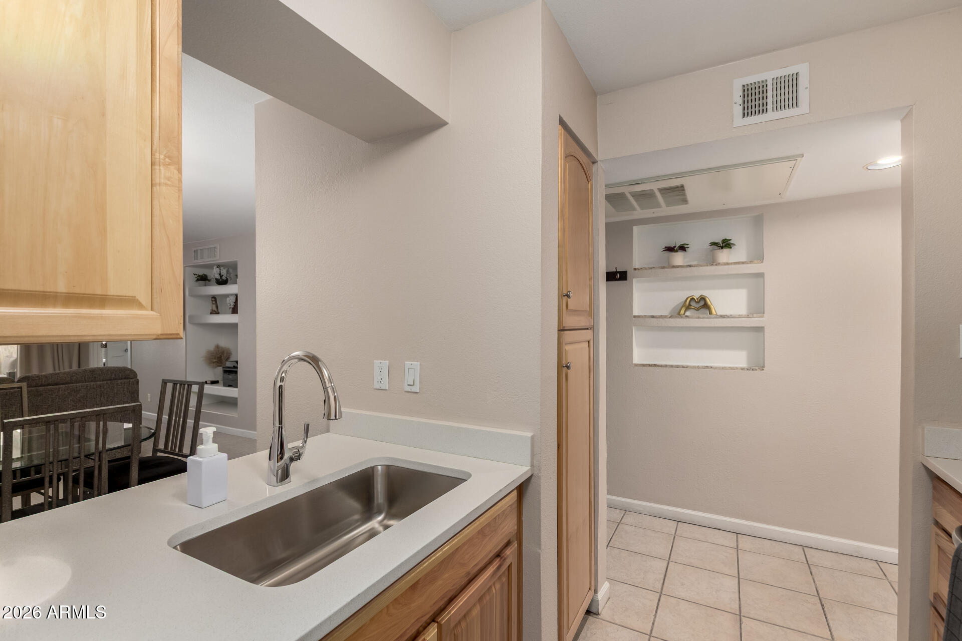 7625 East Camelback Road, Unit A220 Scottsdale, AZ 85251 - Photo 16 of 37 a kitchen with sink cabinets and stove