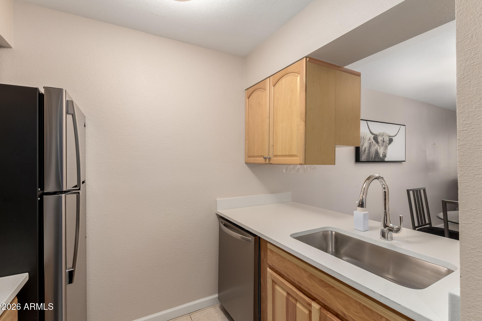 7625 East Camelback Road, Unit A220 Scottsdale, AZ 85251 - Photo 18 of 37 a kitchen with a sink and a refrigerator
