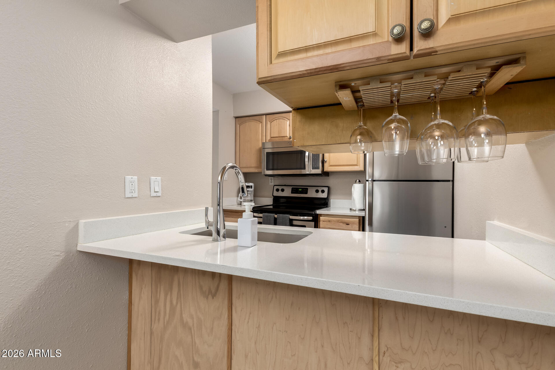 7625 East Camelback Road, Unit A220 Scottsdale, AZ 85251 - Photo 19 of 37 a kitchen with stainless steel appliances a sink a stove and a refrigerator