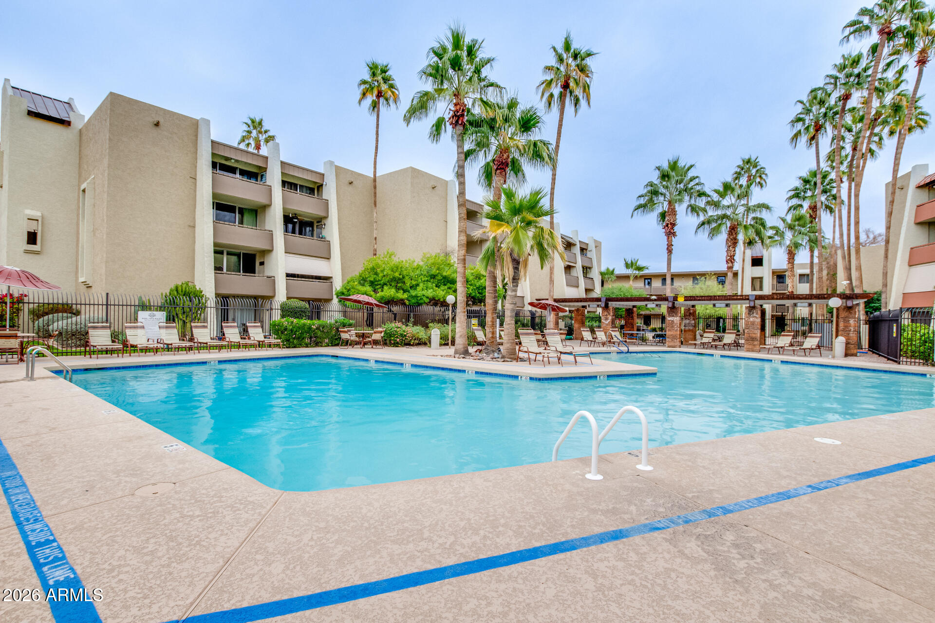 7625 East Camelback Road, Unit A220 Scottsdale, AZ 85251 - Photo 30 of 37 a view of swimming pool with outdoor seating and plants