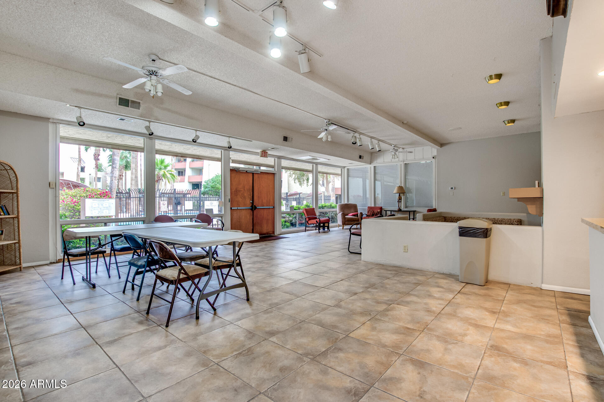 7625 East Camelback Road, Unit A220 Scottsdale, AZ 85251 - Photo 32 of 37 a kitchen with stainless steel appliances kitchen island granite countertop a table chairs sink and cabinets