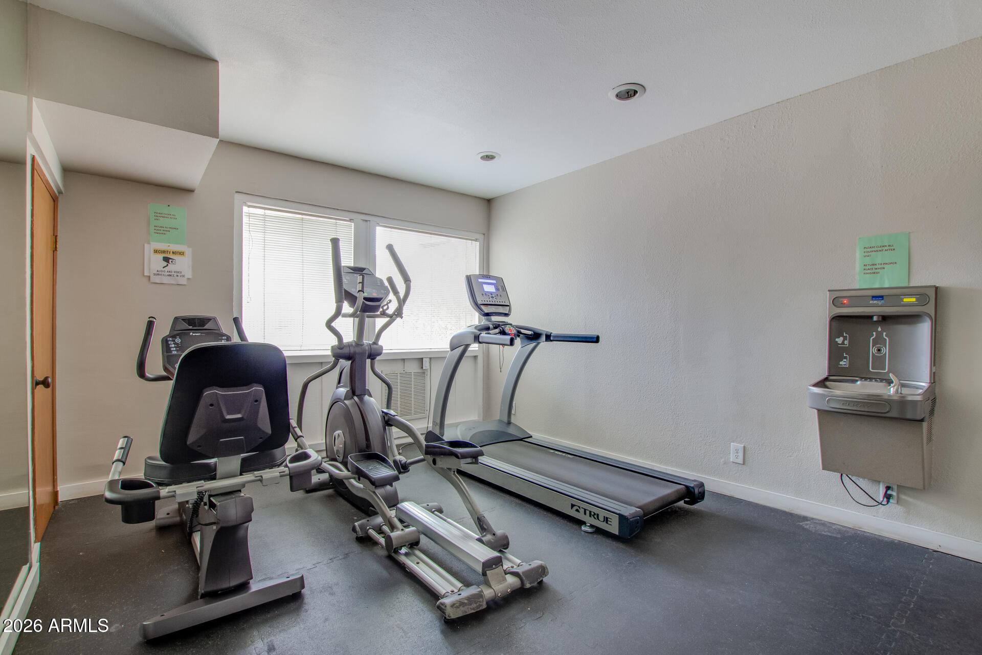 7625 East Camelback Road, Unit A220 Scottsdale, AZ 85251 - Photo 35 of 37 a room with gym equipment and windows