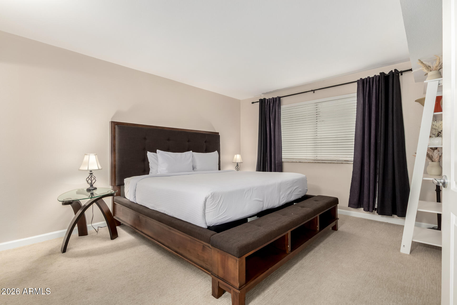 7625 East Camelback Road, Unit A220 Scottsdale, AZ 85251 - Photo 6 of 37 a bed sitting in a bedroom next to a window and a larger closet