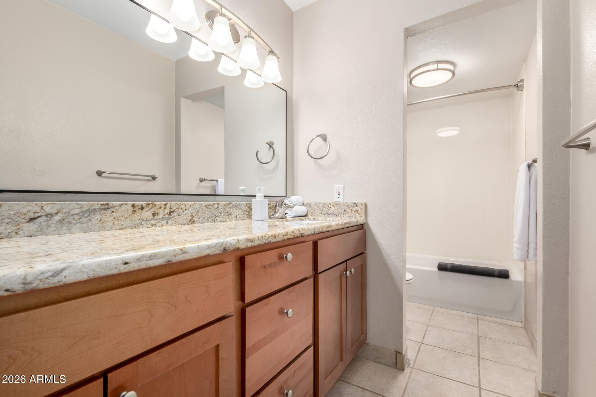 7625 East Camelback Road, Unit A220 Scottsdale, AZ 85251 - Photo 7 of 37 a bathroom with a sink and a mirror