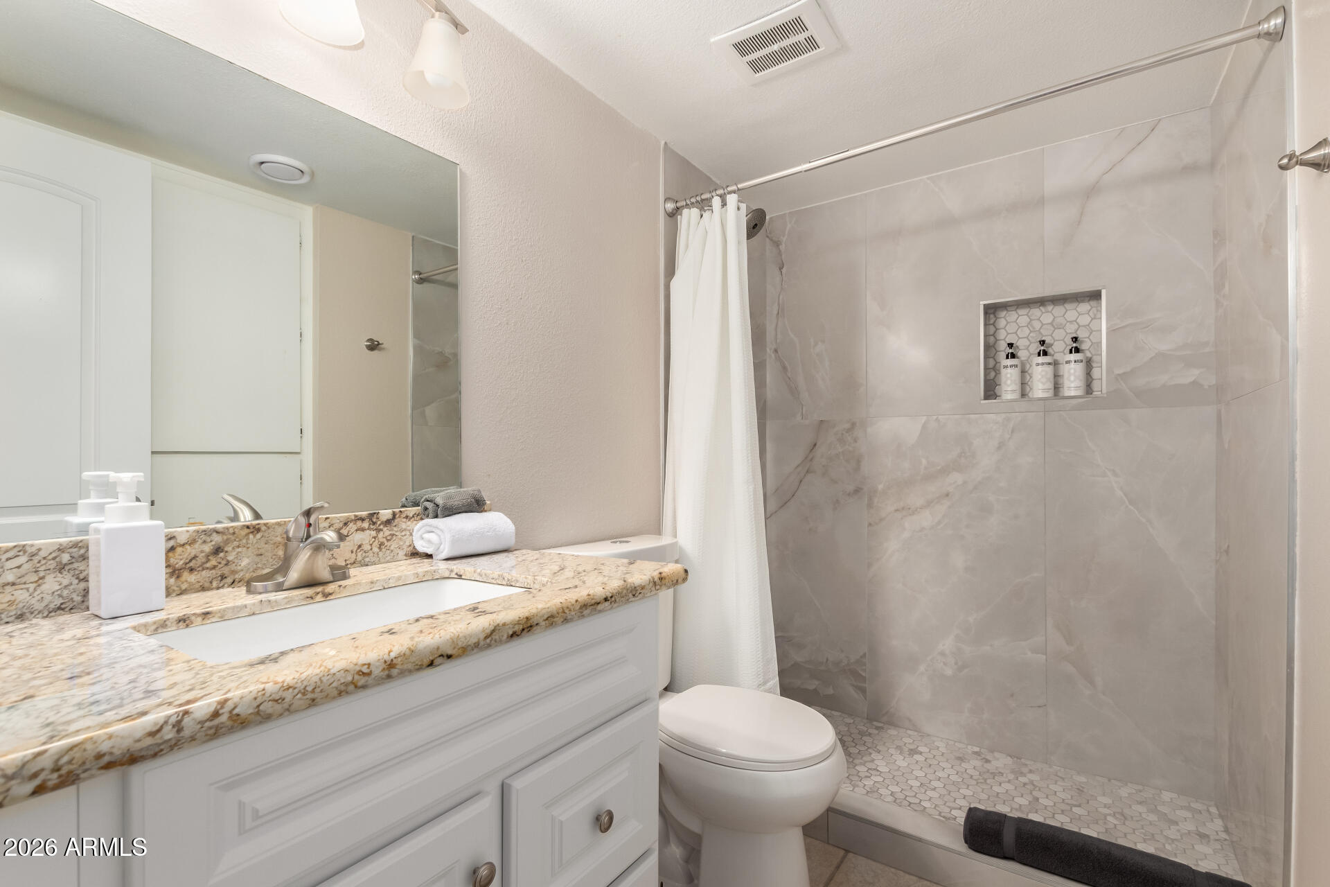 7625 East Camelback Road, Unit A220 Scottsdale, AZ 85251 - Photo 9 of 37 a bathroom with a granite countertop sink toilet and shower